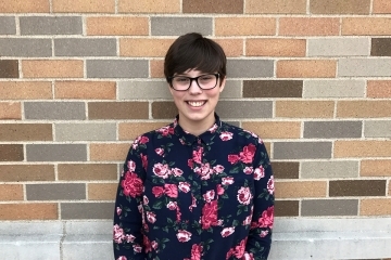 Ashley Hicks in front of a brick wall