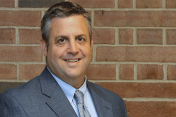 Donald Murphy headshot against brick wall