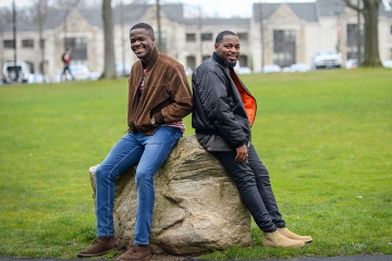 Lang Fonjoe ’17 and Junior Doh ‘17 against a boulder on the Great Lawn