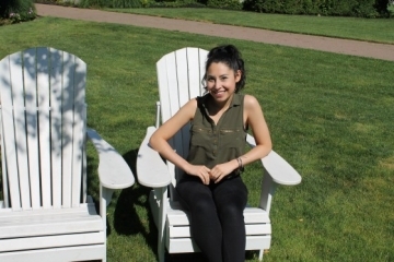 Nicole Ariza sitting in Adirondack chair