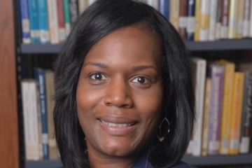 Sandra M. Echols headshot in front of bookshelves