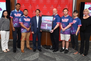 Team and School Dean handing President Gempesaw