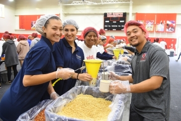 St. John's students pose by catering dishes during service week 2019