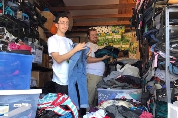 Kyle Burnell and Sean Montafort organizing clothes