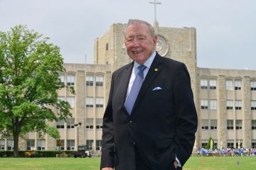 John Clarke posing infront of St. Augustine Hall