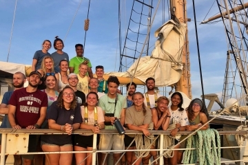 Group of people including Connor Cummings on a boat out to sea