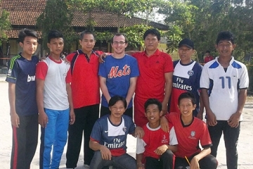 Dylan Kitts poses for picture with group of young men