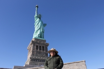 Flor D’Luna (Arellano) Blum in front of the Statue of Liberty