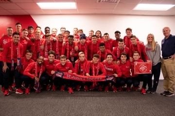 2019 Men's Soccer Team holding a St. John's Soccer Banner