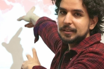 Errol Abaid ‘08CPS pointing at a board