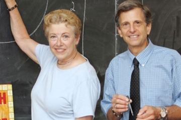 Mark and Helen Levy in front of a chalkboard