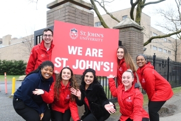 Students holding We Are St. John's Sign