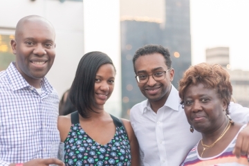 Four African American alumni pose for a group photo