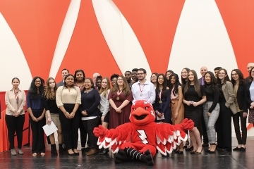 High School students pose with Johnny as they celebrate the end of the Difference Makers program
