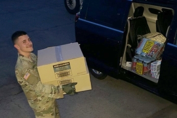 Lenny Jaramillo Carrying Boxes to Van