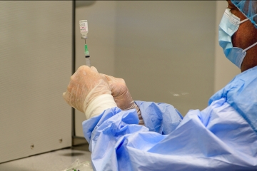 Dr. Longo with Covid vaccine syringe