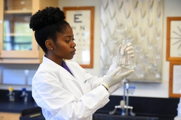 CFPP student in a white lab coat in the lab classroom