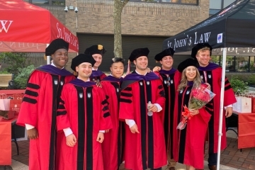 2021 St. John's School of Law graduates in red graduation regalia