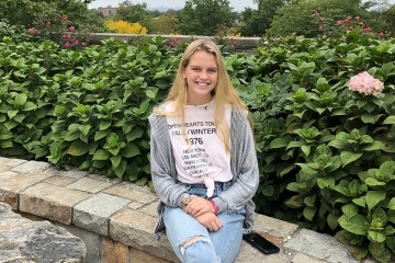 Katie Flynn sitting on stone ledge