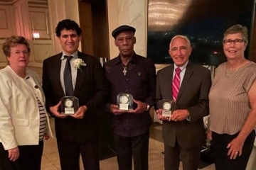 Joseph Sciame holding award with 4 other recipients