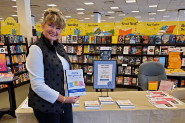 Arlene M. Karole holding her book &quot;Just Diagnosed&quot; inside a bookstore