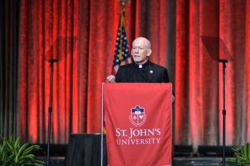 President Shanley speaking at podium on stage