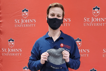 IT employee posing for picture in front of step and repeat