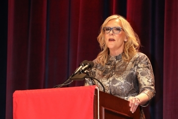 Tricia Griffith standing at podium making speech