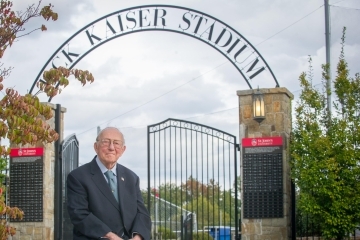 Jack Kaiser sitting infront of Kaiser Stadium