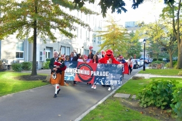 The start of the parade with a bag piper leading the way 