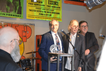 Wayne Robins holding award at LI Music Hall of Fame