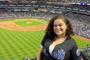 St. John's Law student Samantha Velez wearing a New York Mets jersey in the stands at Citi Field.