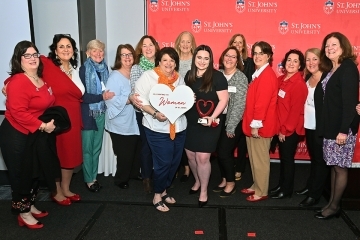 Group of St. John's women holding Women of St. John's sign