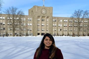 Aishwarya Saraswat standing in front of campus building