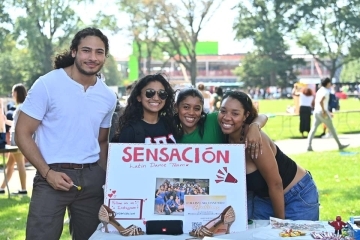 Latin Dance Team poster with students at the Student Activities Fair