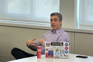 Max H sitting at front of class moderating lecture