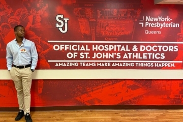jelanie estrada infront of wall graphic for New York Presbyterian Hospital