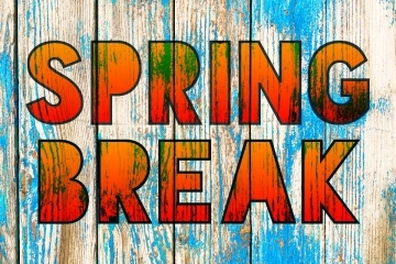 Graphic with the words Spring Break written on blue-tinged wood paneling.