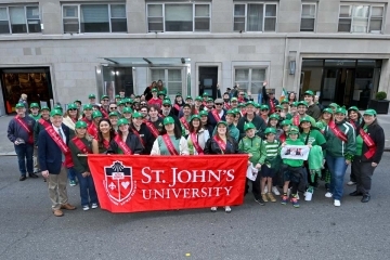 St. Patrick’s Day Parades participants holding St. John's University banner