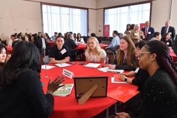 TSOE students sitting around a red table interacting