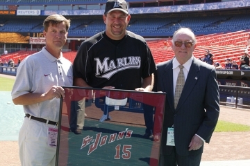 Wayne Rosenthal in his Marlins jersey holding a framed St. John's jersey