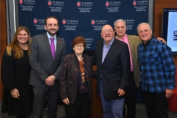 Jerry Della Femina poses for a group photo with St. John's community members