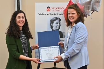Two women from St. John's holding up certificate of appreciation