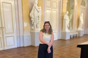 Alexandra McGill ’22C St Johns Alumna standing in hallway with statues