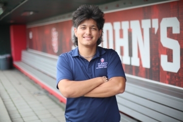 An advertising major student poses in front of the St. John's University building in Queens, NY