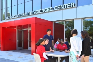 Students sitting at table outside the St. John's St. Vincent Health Science Center