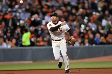 Rich Aurilia throwing a baseball on the field during a San Francisco Giants game