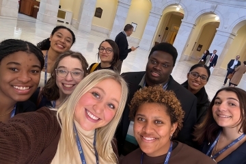 St. John'st students taking a selfie in the lobby of a building
