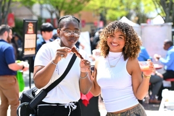 Two students eating ribs at the St. John's BBQ Competition