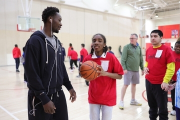 St. John's athlete with special needs student playing basketball